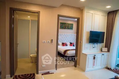 Luxurious modern bedroom with ensuite bathroom and wall-mounted TV in stylish apartment.