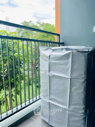 Charming balcony with lush greenery view, perfect for relaxation and enjoying nature.