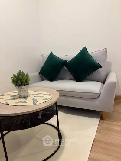 Cozy living room with stylish sofa and modern coffee table, perfect for relaxation.