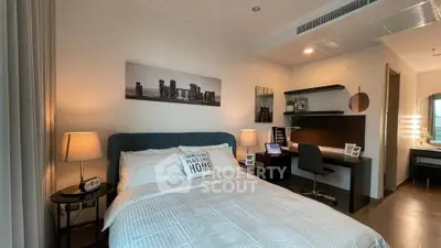 Modern bedroom with cozy decor and workspace, ideal for urban living.