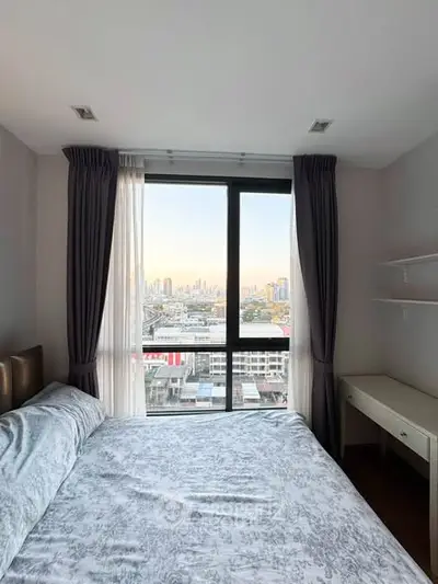 Cozy bedroom with stunning city view and ample natural light.