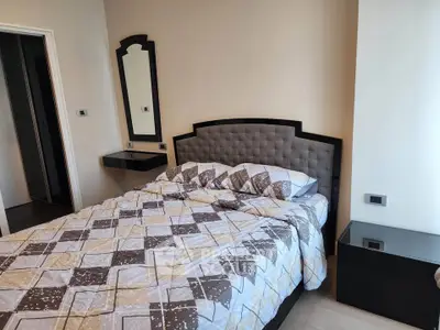 Cozy bedroom with stylish headboard and modern decor, perfect for relaxation and comfort.