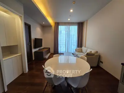 Modern living room with elegant dining area and city view balcony