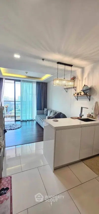 Modern open-layout living room with stylish decor and large windows offering a stunning city view.