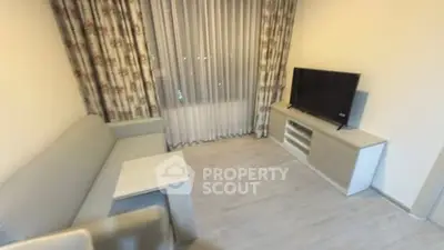 Modern living room with sleek furniture and large window curtains