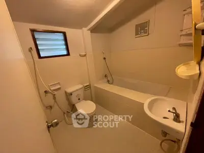 Cozy bathroom with bathtub and modern fixtures in a well-lit space.