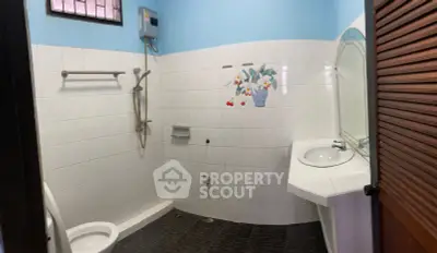 Spacious bathroom with modern shower and elegant sink in a cozy home.