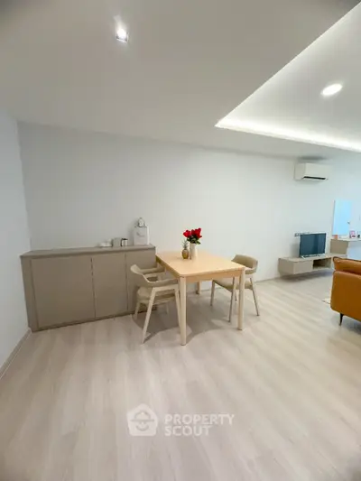 Modern living room with minimalist decor and wooden flooring