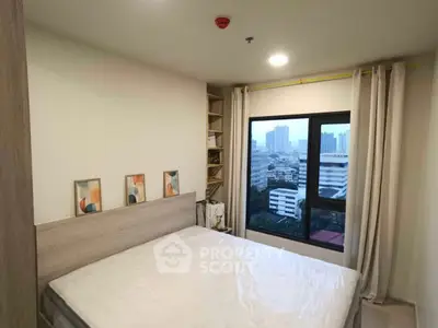 Cozy bedroom with city view, modern decor, and ample natural light