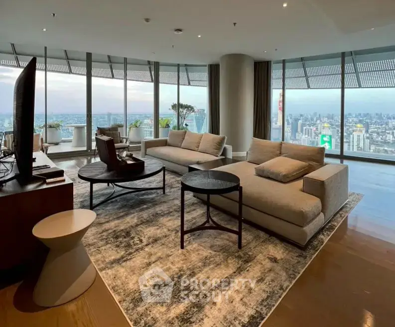 Luxurious high-rise living room with panoramic city views and modern furnishings.