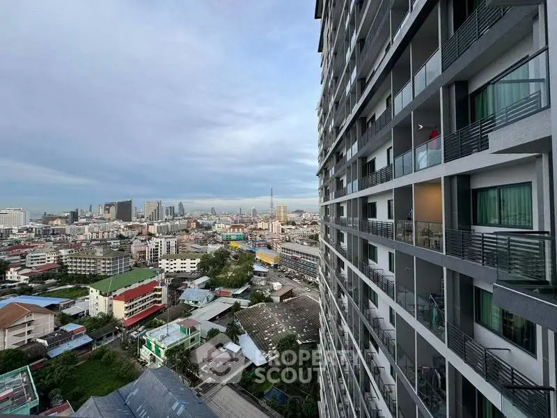 Stunning cityscape view from a modern high-rise apartment balcony, showcasing urban living at its finest.