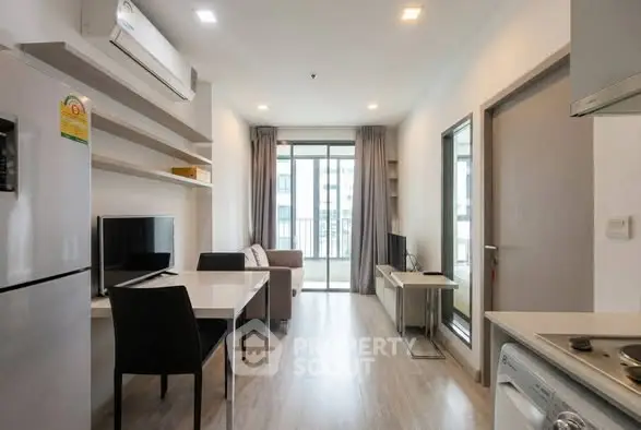 Modern living room with sleek furniture and balcony view in a stylish apartment.