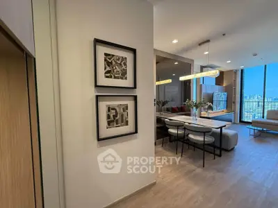 Modern open-plan living and dining area with stylish decor and city view.