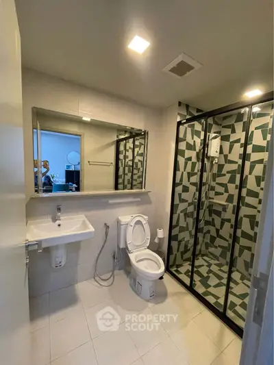 Modern bathroom with stylish shower and large mirror