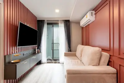 Modern living room with stylish decor and balcony access, featuring a wall-mounted TV and air conditioning.