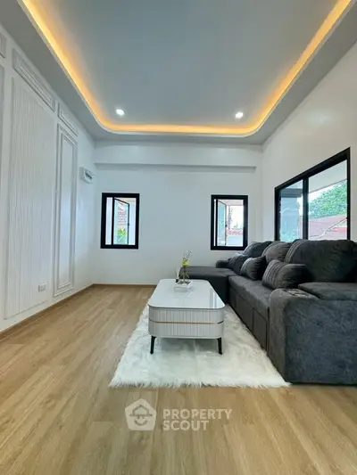 Spacious modern living room with elegant lighting and cozy seating