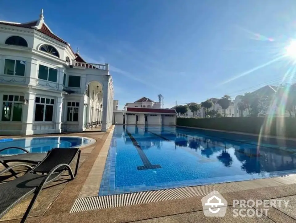 Luxurious villa with stunning outdoor pool and elegant architecture under clear blue sky.