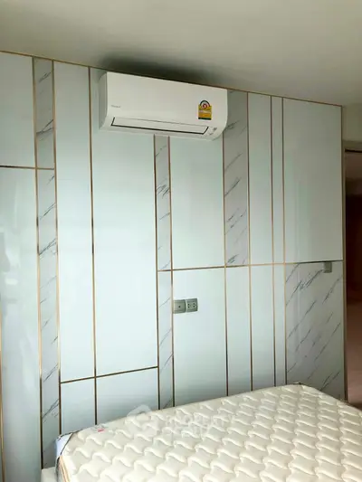 Modern bedroom with stylish wall paneling and air conditioning unit