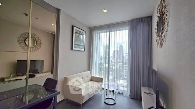 Modern living room with city view, featuring stylish decor and natural light.
