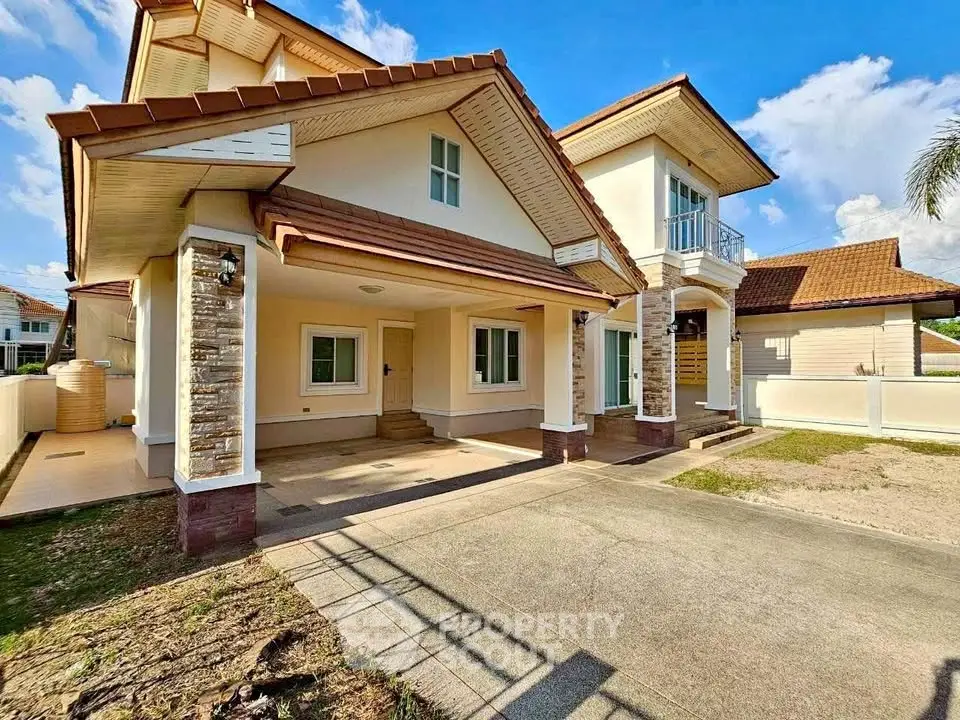 Charming two-story house with spacious driveway and elegant stone accents.