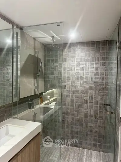 Modern bathroom with glass shower and stylish tile design