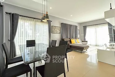 Modern living room with elegant dining area and natural light