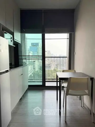 Modern kitchen with sleek design and city view from large window, perfect for urban living.