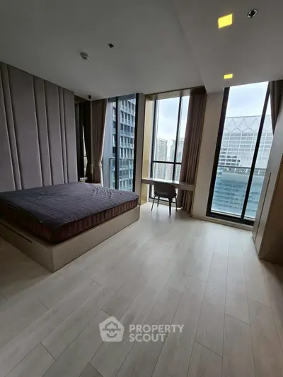 Spacious bedroom with city view and modern design in high-rise apartment