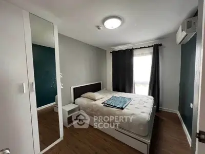 Cozy bedroom with modern decor and ample natural light
