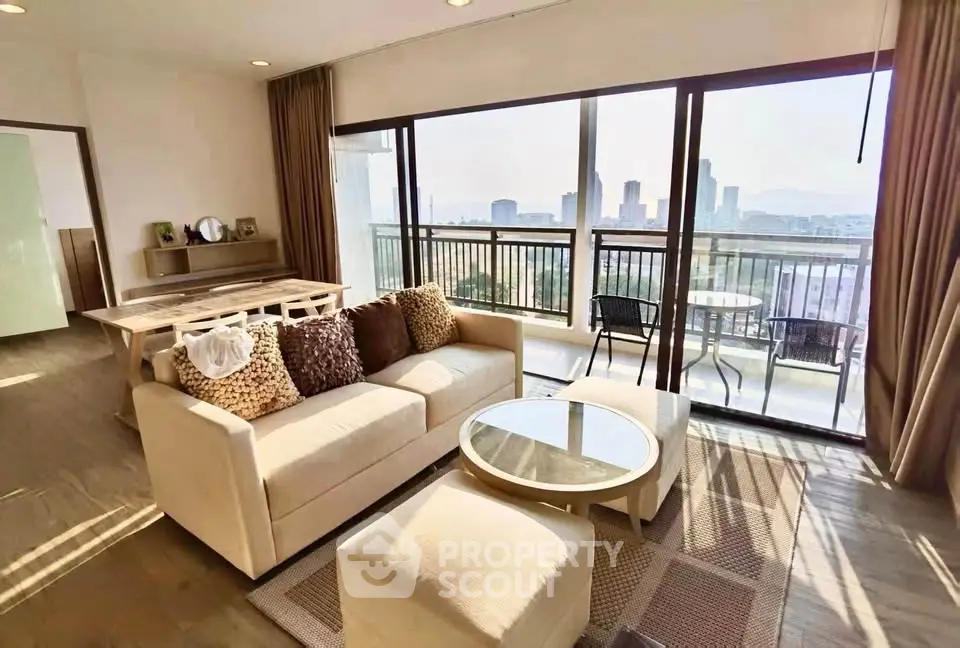 Spacious living room with city view and large balcony in modern apartment