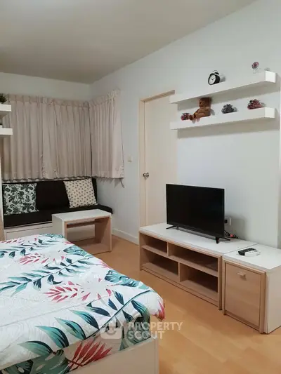 Cozy bedroom with modern decor and entertainment setup