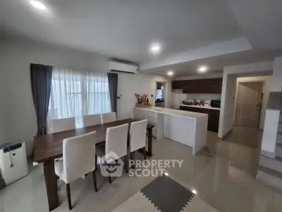 Spacious modern dining and kitchen area with sleek design and ample natural light.