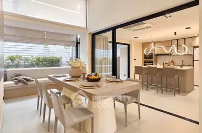Modern open-plan kitchen and dining area with sleek design and natural light