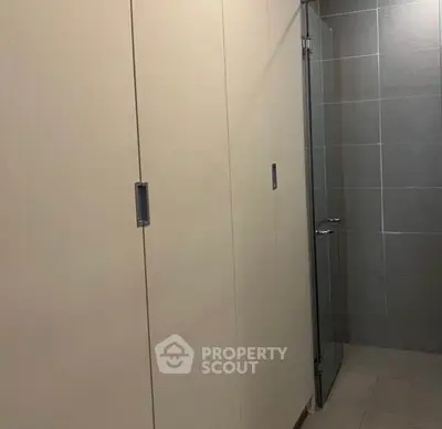 Modern bathroom with sleek glass shower door and minimalist design.