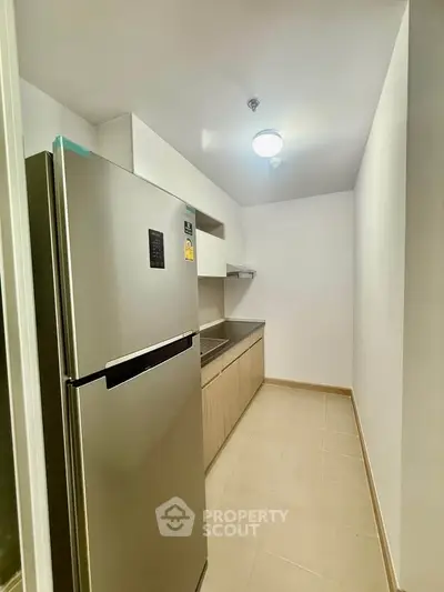 Modern kitchen with sleek stainless steel fridge and minimalist design