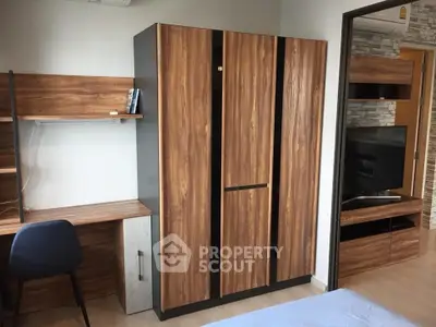 Modern bedroom with stylish wooden wardrobe and study desk