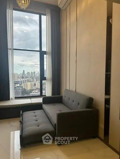 Modern living room with city view and stylish gray sofa