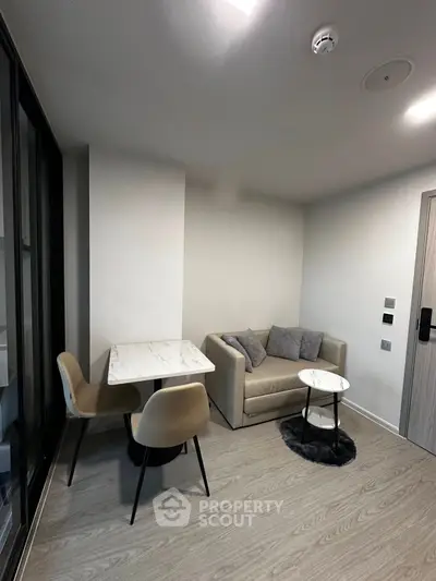 Modern living room with cozy sofa and dining area in stylish apartment