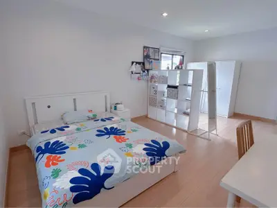 Spacious bedroom with modern decor and ample natural light