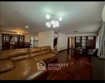 Spacious living room with elegant leather sofa and modern lighting in a luxurious home.