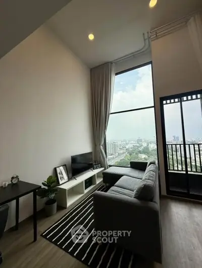 Stunning high-rise living room with floor-to-ceiling windows and city view, featuring modern decor and cozy seating.