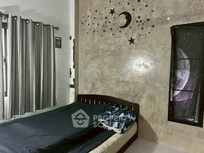 Cozy bedroom with celestial-themed decor and natural light