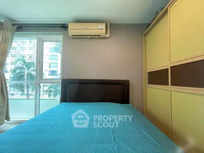 Cozy bedroom with modern air conditioning and large wardrobe, overlooking a scenic view.