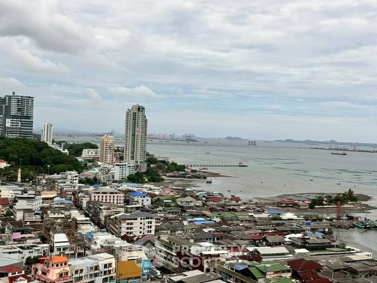 Stunning coastal cityscape view with high-rise buildings and ocean horizon.