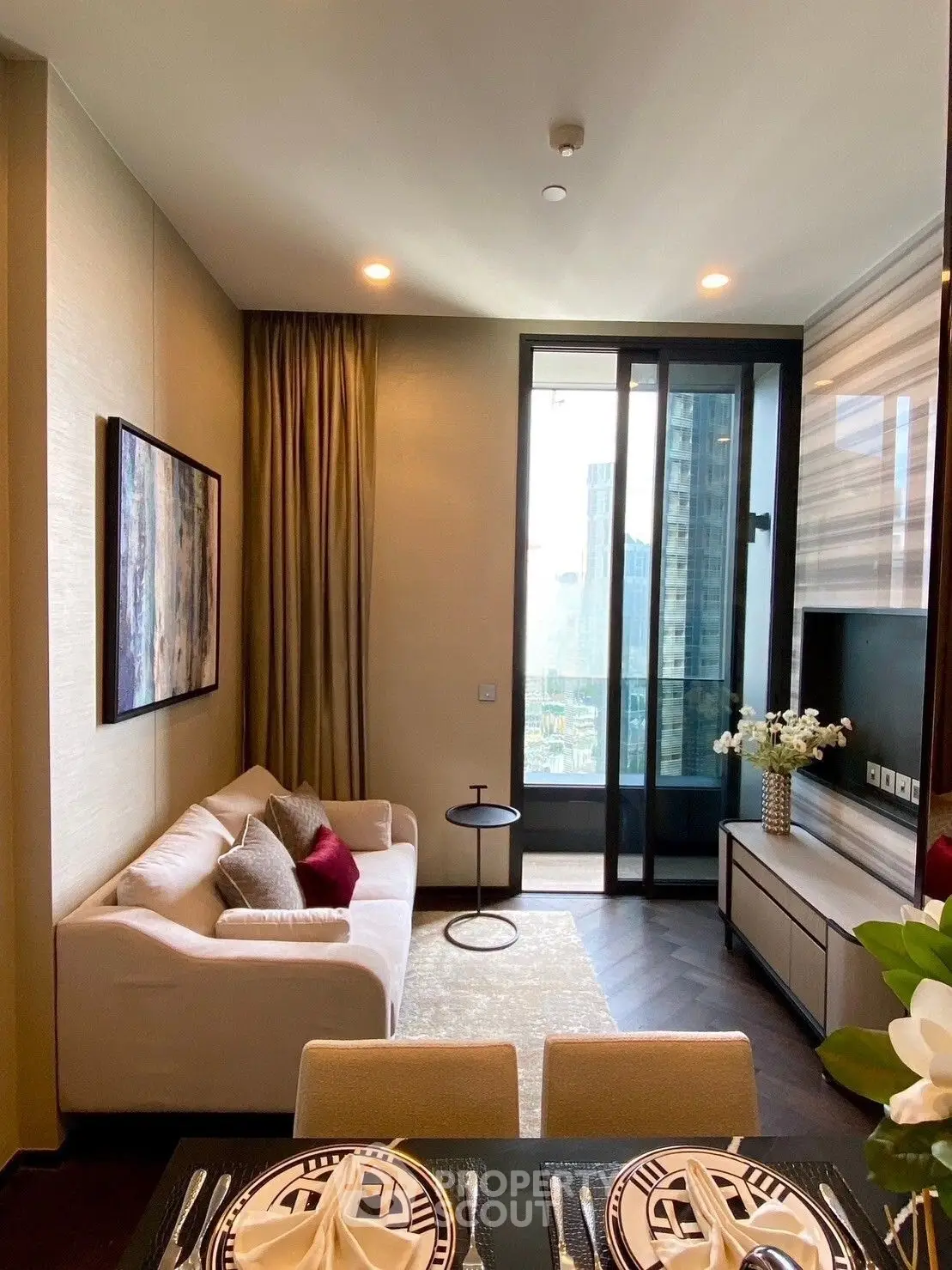 Modern living room with elegant decor and city view from large window.