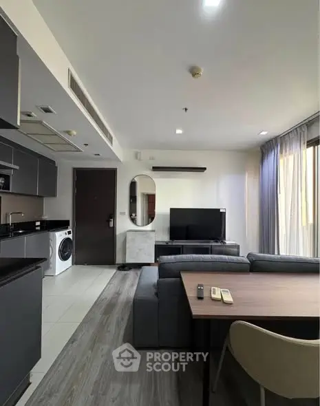 Modern living room with sleek furniture and open kitchen layout