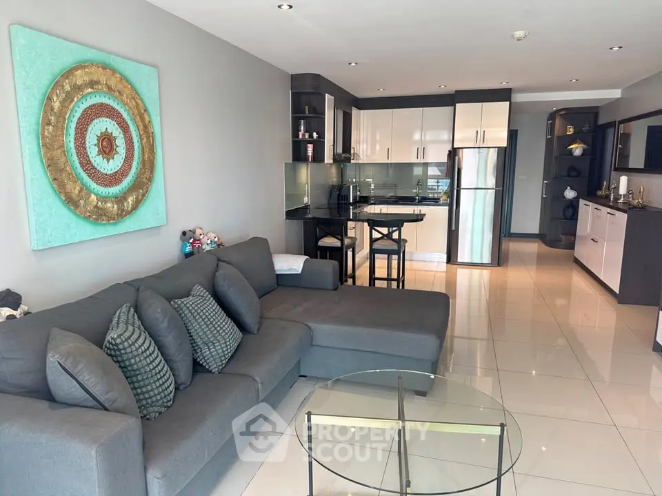 Modern open-plan living room with sleek kitchen and stylish decor