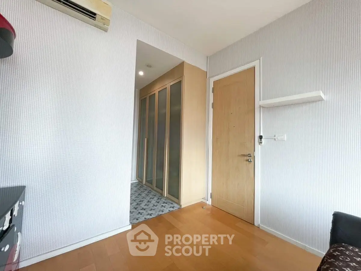 Modern interior with wooden flooring and sleek closet design