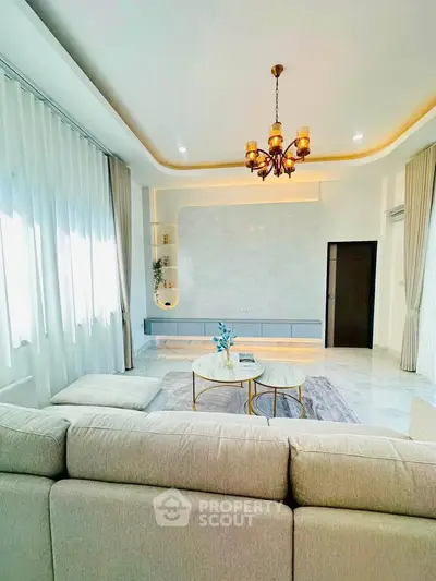 Luxurious living room with elegant chandelier and modern decor