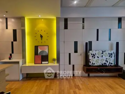 Modern living room with stylish wall decor and wooden flooring